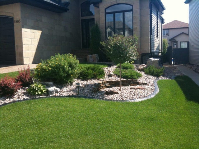 curb- nice shrub bed on a slope